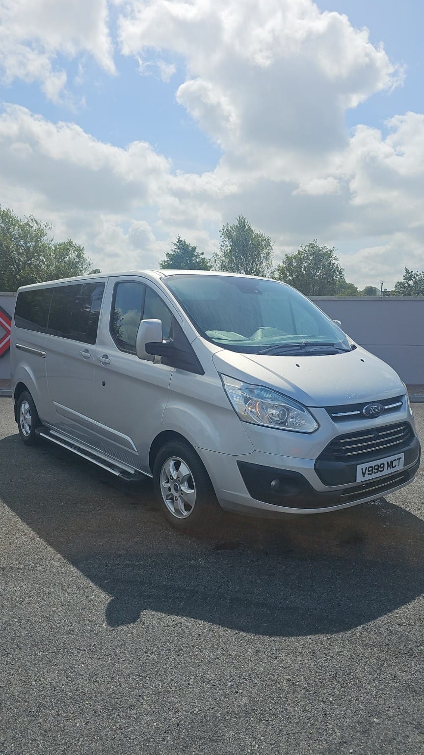 MC Transfers minivan, side view showing passenger doors
